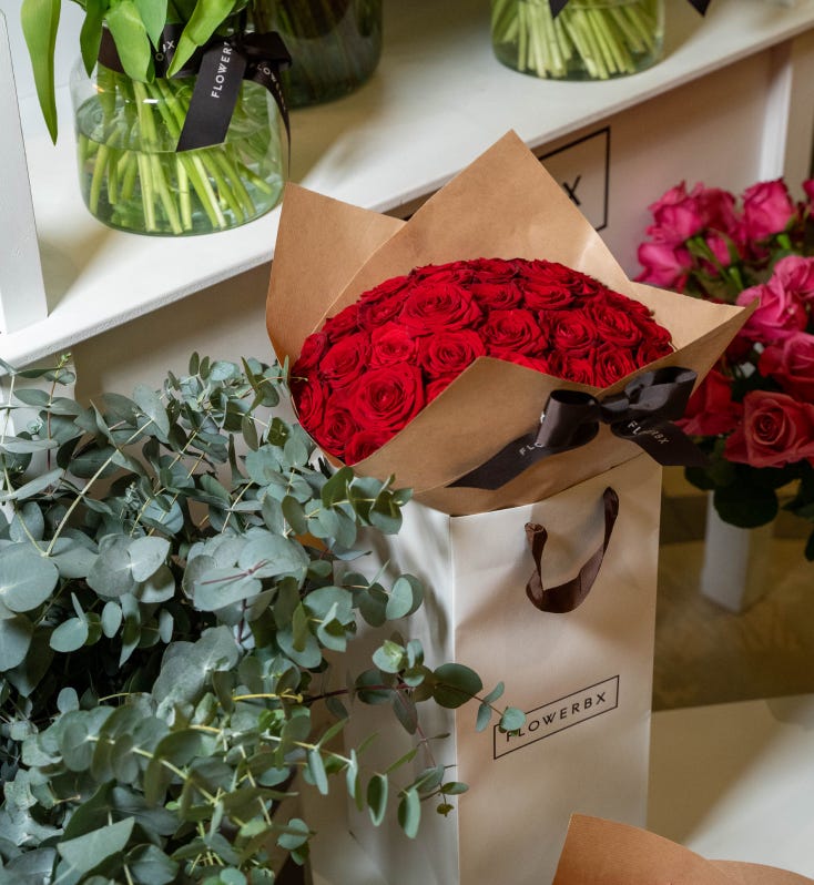 100 Red Roses in a glass vase